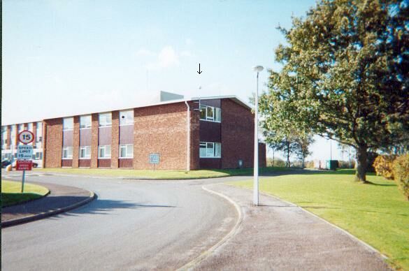 Daresbury Active station attached to south east face of Research Laboratory building by stainless steel pole. Location of antenna shown by black arrow.