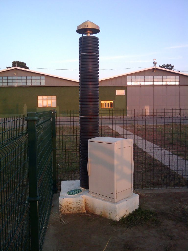 GNSS antenna and concrete pillar in Instituto Nacional de Meteorologia, Virgen del Camino Airport. View: from east to west.