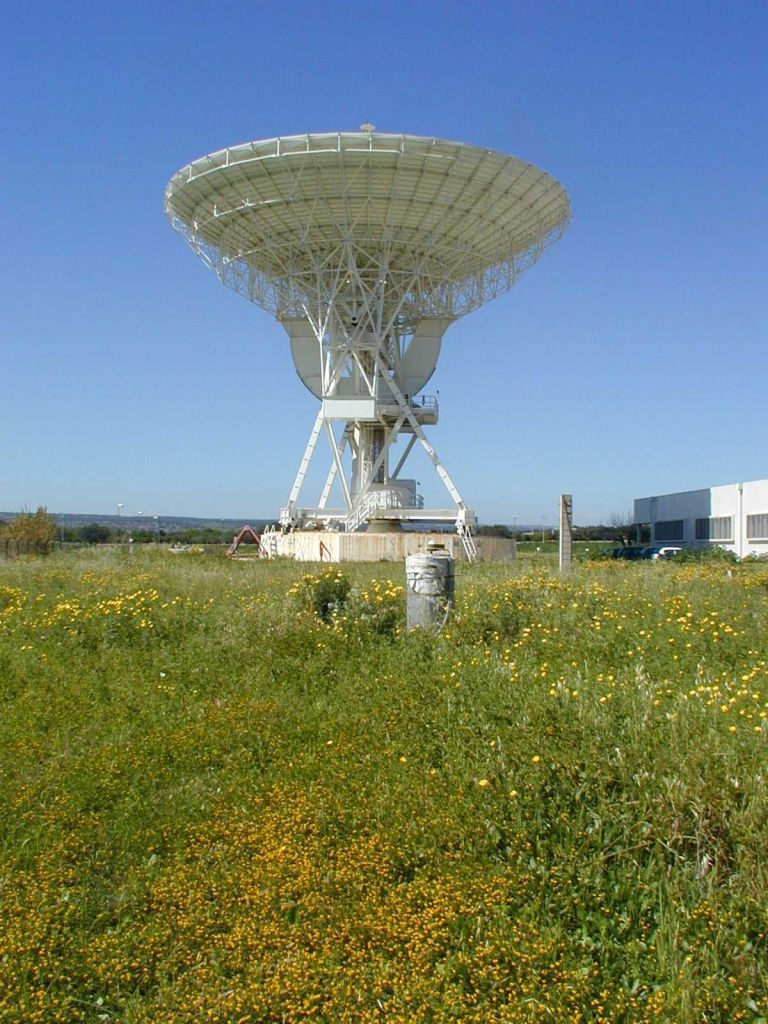 GPS antenna with pillar and VLBI antenna.