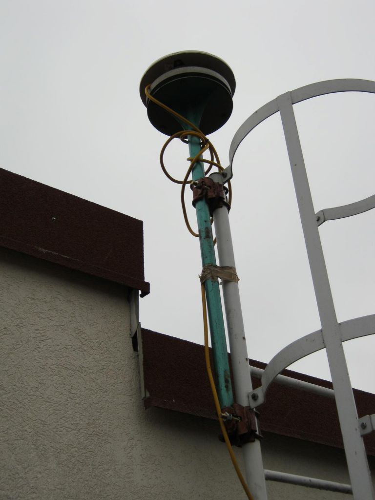The GNSS antenna is installed on a iron pillar which is attached to the metal stairs.