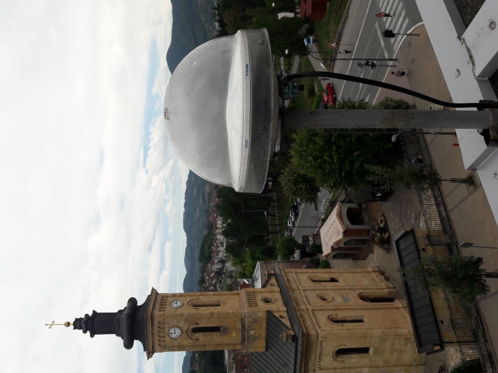 The view of Trimble Zephyr 3 geodetic antenna with protective TZGD dome installed on iron pillar attached to the concrete fence on the roof of local cadaster building (TRM115000.00).
