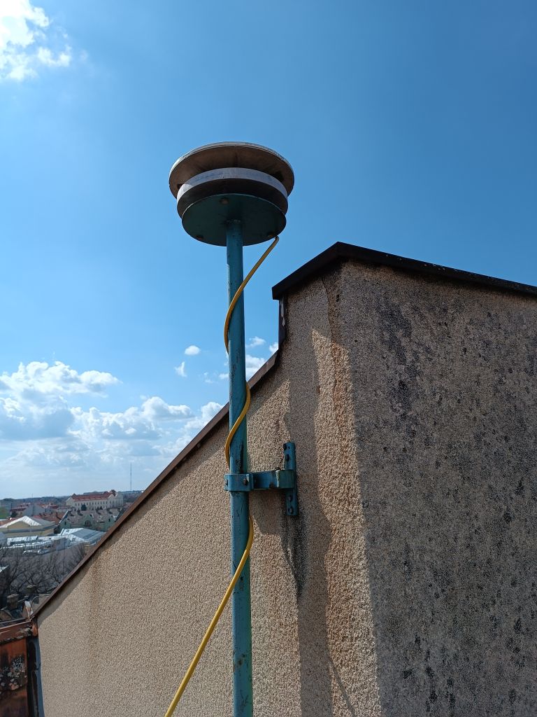 TRM41249.00 NONE CORS antenna installed on iron pillar attached to the concrete wall in Subotica municipality.
